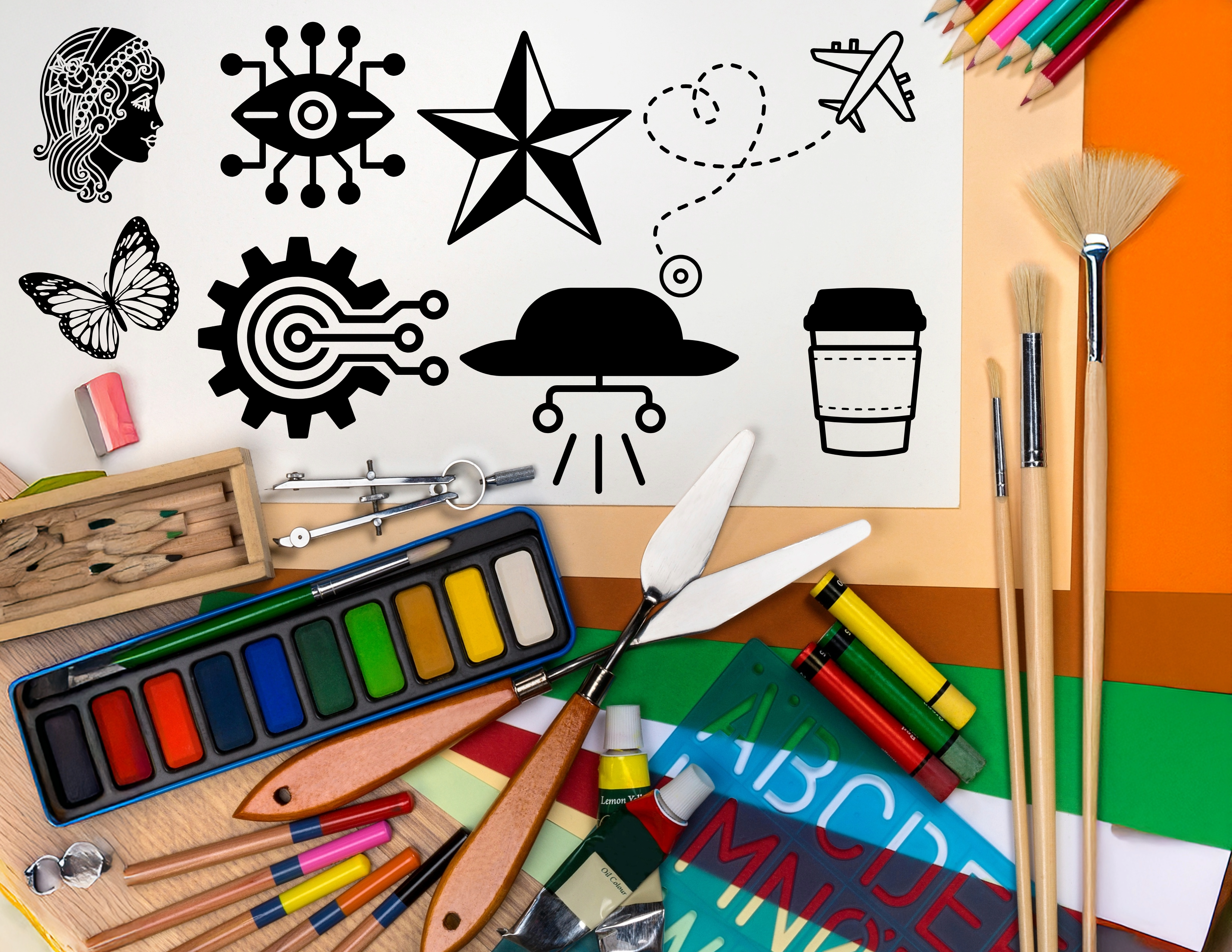 Creative tools and icons on a desk.